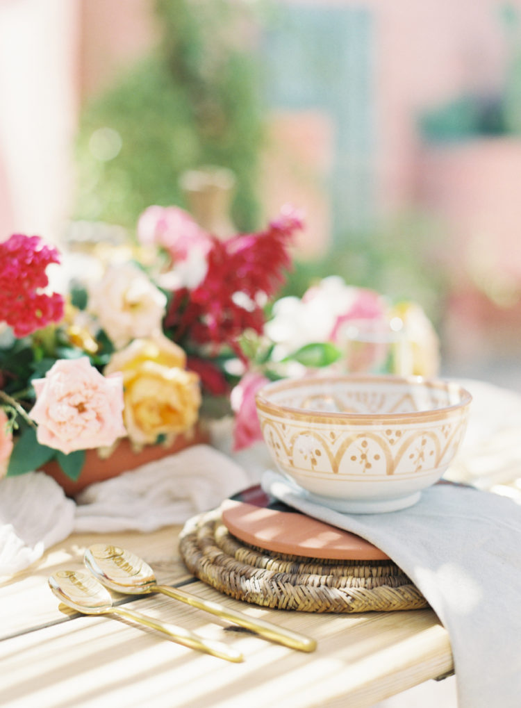 Local crockery, wicker chargers, bold blooms helped to create a chic tablescape