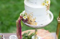 09 The wedding cake was decorated with gold leaf and lush blooms
