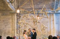 09 a brass tetrahedral installation for thw wedding ceremony looks breathtaking