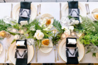 10 The wedidng tablescape was done in black, white and gold and with lots of greenery