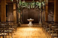 10 an industrial space with wooden pillars and hanging greenery and candle holders