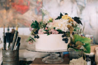 11 The simple wedding cake was decorated with lush blooms and some fruits cascading down