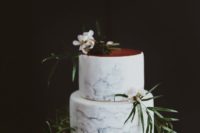 11 blue marbleized wedding cake with a copper top and foliage for decor