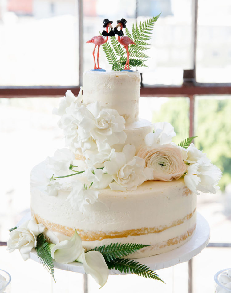 The wedding cake was a semi-naked one, with fresh blooms and pink flamingo toppers