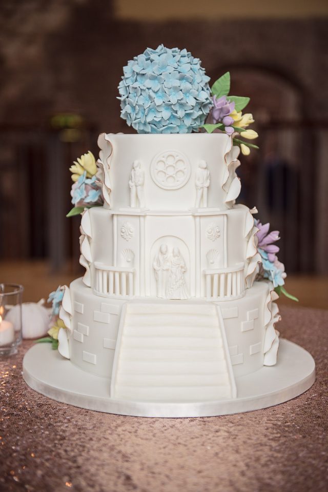 The wedding cake was a white one, with the pirate castle theme, and decorated with pastel sugar flowers