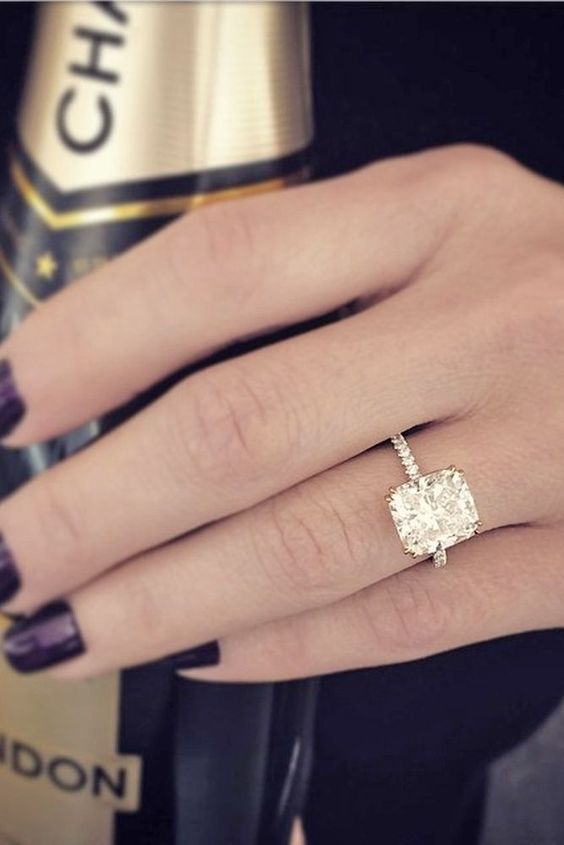 a gold engagement ring with a large square diamond is a stylish idea to try