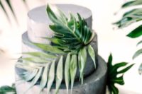 13 a concrete wedding cake with tropical leaves for a modern tropical wedding