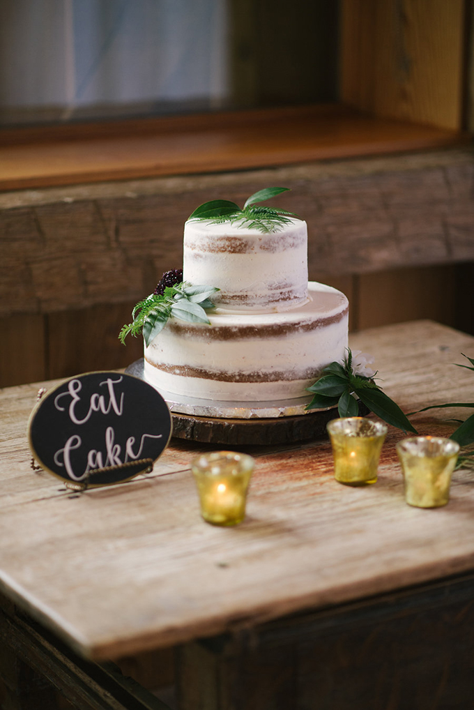 The wedding cake was a demi-naked one topped with greenery for a rustic feel