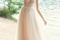 14 a champagne wedding dress with an illusion neckline, cap sleeves, lace appliques and a flowy skirt