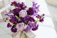 14 decorate the aisle chairs with gorgeous bouquets with violet and lilac blooms with a grey ribbon bow