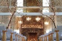 14 whole trees with lights put in the ceremony space, candles in the fireplace and on the mantel