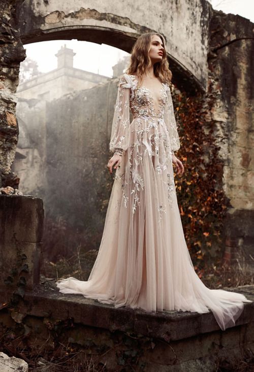 a champagne wedding gown with long bell sleeves, a scoop neckline and floral lace appliques all over