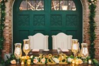 16 a vintage emerald barn door as a backdrop, gold candleholders, letters and a lush greenery garland