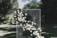 16 white wire wall and a lush floral and greenery decoration attached diagonally