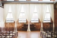 19 exposed brick walls, double height ceilings and aiy curtains and white petals