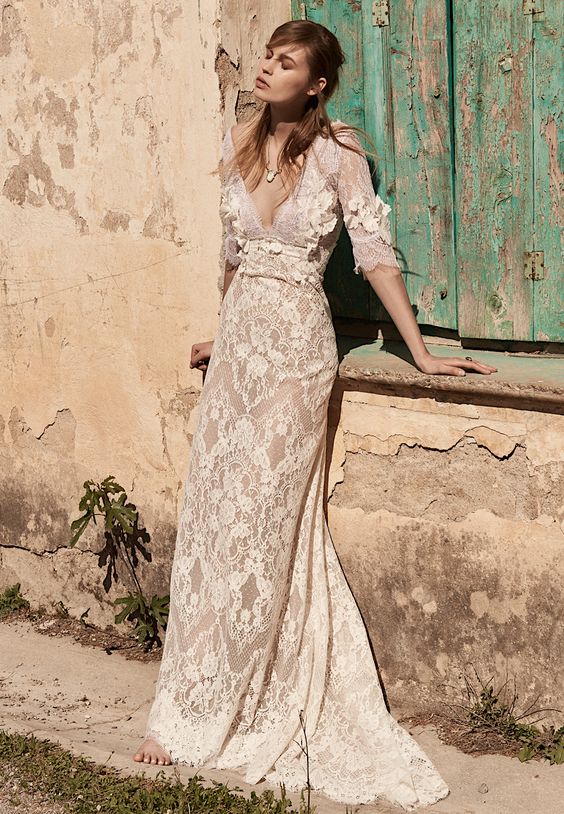 a champagne lace and lace applique wedding dress with a deep neckline and long sleeves for a boho bride