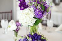 20 a lush bloom centerpiece with purple, violet and white flowers