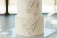 20 a white wedding cake with textural triangles is ideal for a minimalist wedding