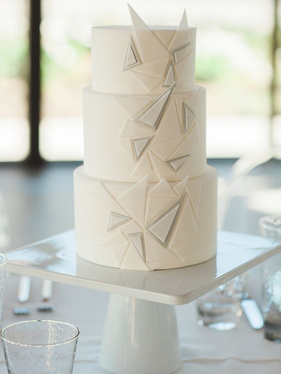a white wedding cake with textural triangles is ideal for a minimalist wedding