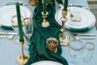 20 emerald napkins and a table runner, emerald candles in gold candle holders and gold cutlery and gold rim glasses