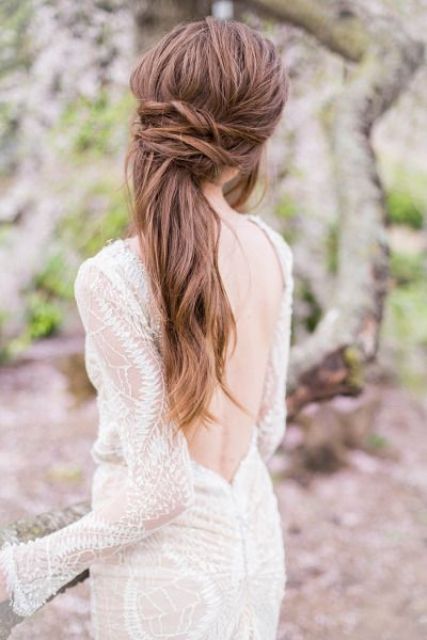 a twisted messy half updo with bangs looks great on long hair