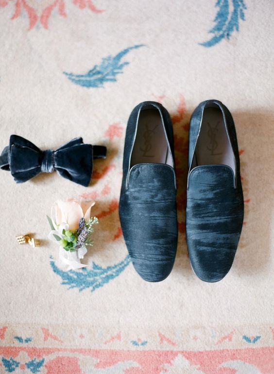 a blue grey velvet bow tie and matching loafers for a trendy groom look
