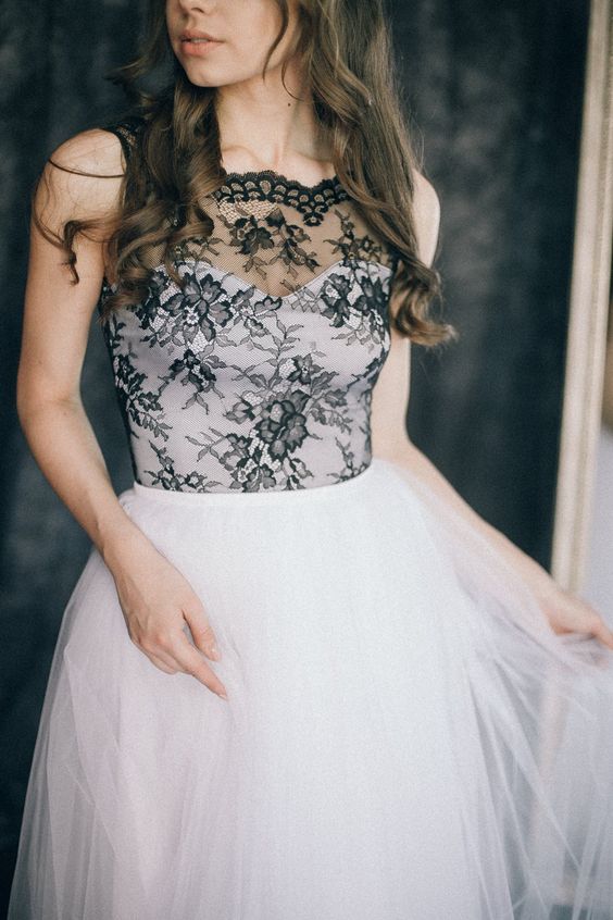 a cream sweetheart neckline wedding dress with a black lace sleeveless top