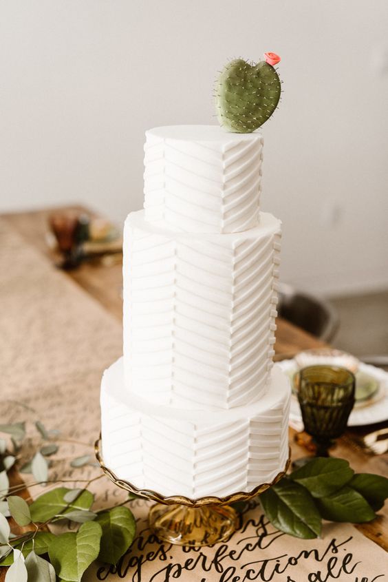a textural chevron wedding cake with a cactus on top is ideal for a desert wedding