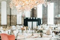 22 an oversized floral and light chandelier over the reception makes the space cuter
