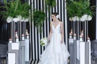 23 a monochrome striped wedding backdrop with matching pillars and greenery arrangements