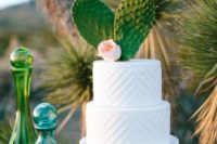23 a white textural chevron wedding cake with two large cacti for a boho desert wedding