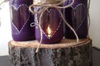 23 ulta violet candle lanterns with hearts, twine and on a wood slice for a rustic wedding