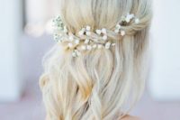 24 a half updo with a twist and waves and baby’s breath tucked in the hair for a boho bride