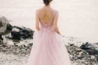 24 a pink wedding gown with a lace applique bodice, cap sleeves, an open back and a layered skirt