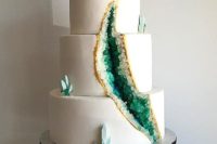 25 a geode wedding cake with a gold edge and emeralds inside
