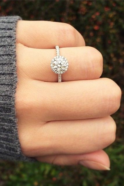 a white gold round diamond engagement ring with a halo is a cute idea