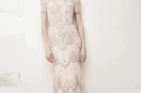 25 an embellished retro-inspired wedding dress with a V-neckline, short sleeves and delicate lace