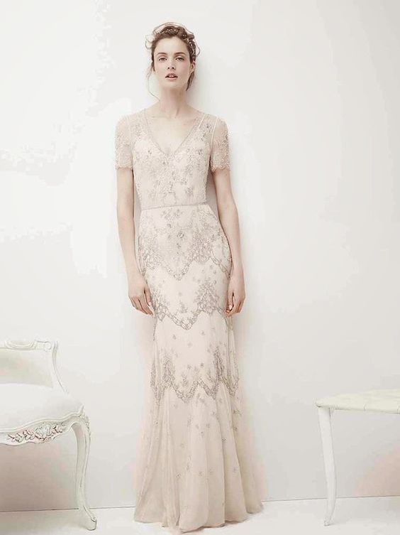an embellished retro-inspired wedding dress with a V-neckline, short sleeves and delicate lace