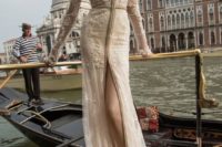 26 Inbal Dror wedding dress with long sleeves, a plunging neckline and a high front slit and a small train, illusion detailing