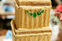 26 a stunning sparkly gold wedding cake with emeralds looks wow and is ideal for an art deco wedding