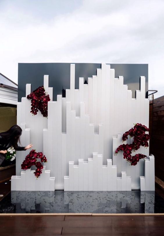 an ultra modern wedding backdrop with burgundy orchids inspired by Icelandic landscapes
