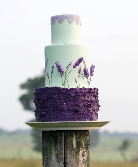 a mint wedding cake with a lavender top and a ruffled violet layer with lavender