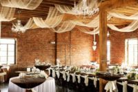 27 the reception space can be decorated with airy and liht fabric and glam chandeliers