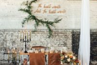 28 the sweetheart table decorated with leather table runners, candles and florals