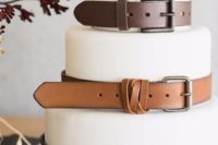 29 white fondant wedding cake with brown leather belts for an industrial wedding