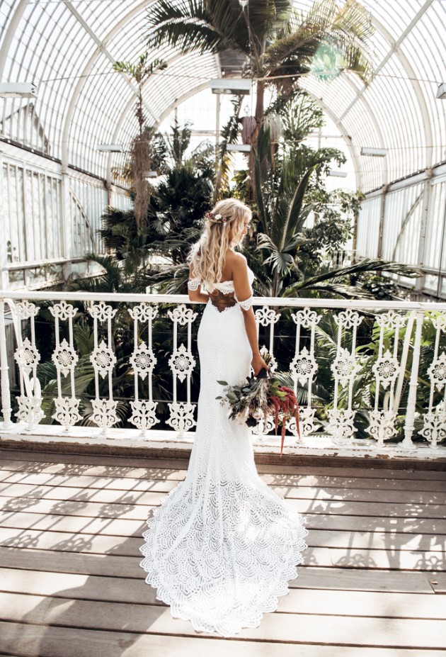 a fantastic off the shoulder lace mermaid wedding dress with a train that showed off a tattoo on the back