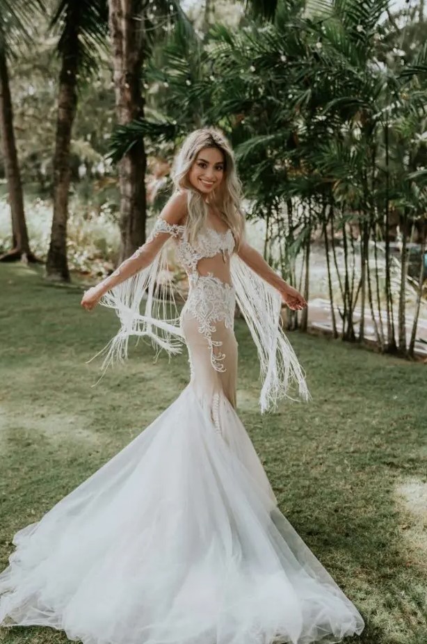 a fantastic off the shoulder lace mermaid wedding dress with fringe, a train and beading plus a sexy cutout right on the ABS