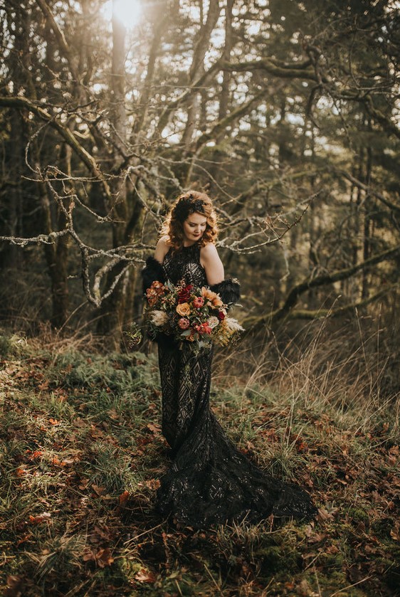 a gorgeous black lace embellished mermaid wedding dress with a halter neckline and a train plus a black faux fur coverup