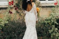 a lace mermaid off the shoulder wedding dress with an open back and long sleeves plus a train for a boho bride