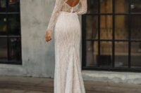 a mermaid lace wedding dress with a high neckline, long sleeves, a keyhole back and a short train with a touch of bling is amazing